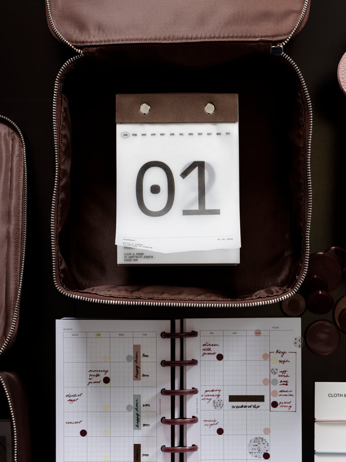 2026 Today Tear Off Pad nested inside of a organizing bag on a table with a filled out planner.