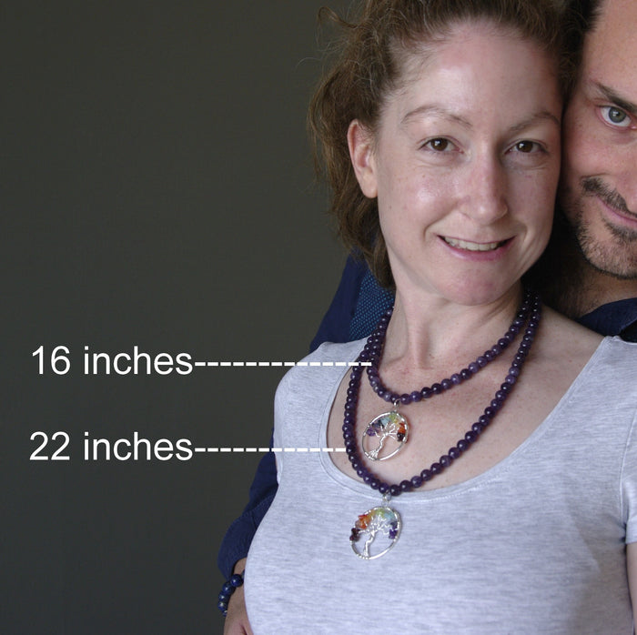 female model wearing 16 and 22 inches chakra stone tree of life wire wrapped pendants on beaded amethyst necklace and male model behind