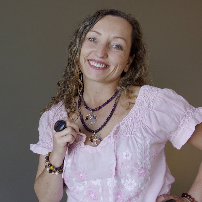 female model wearing 16 and 22 inches chakra stone tree of life wire wrapped pendants on beaded amethyst necklace