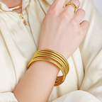 a person wearing gold bracelets