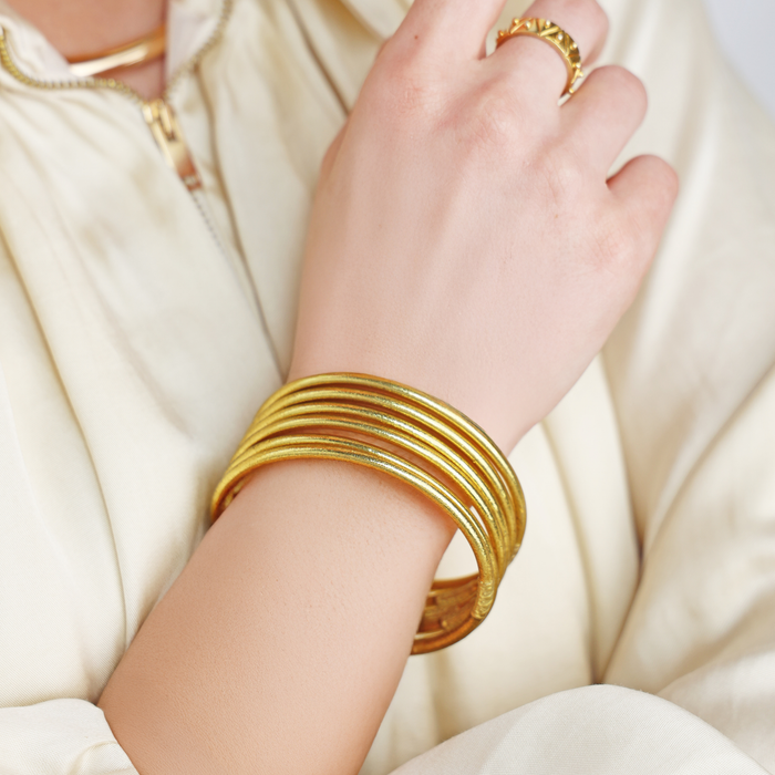 a person wearing gold bracelets