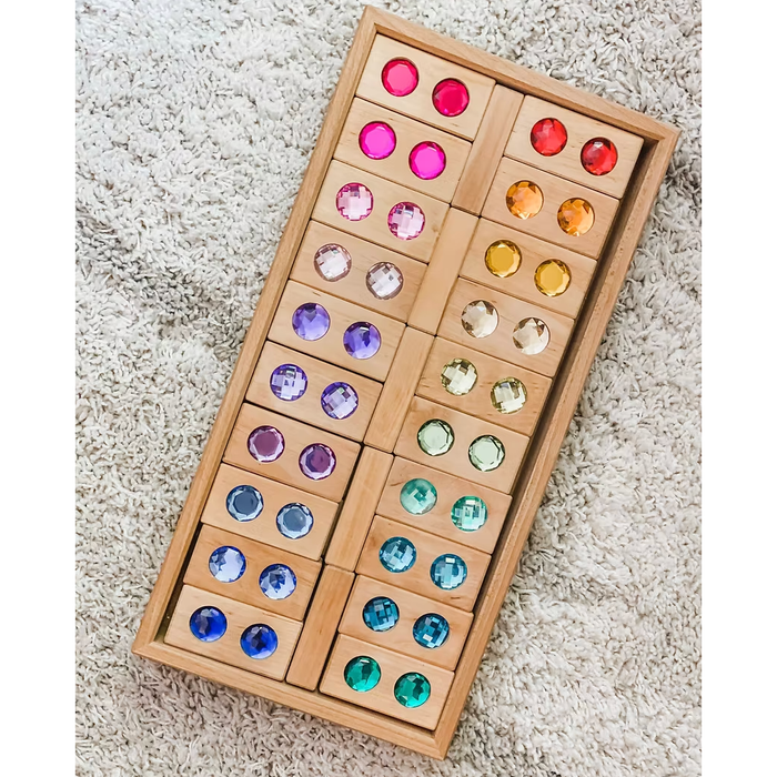 Wooden block puzzle with colored gemstones on a beige carpet