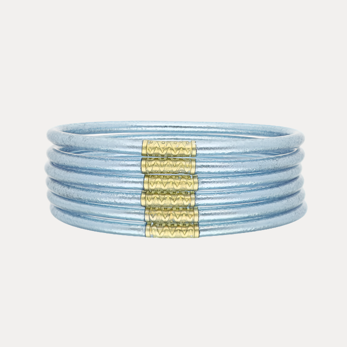 a stack of blue and gold bracelets