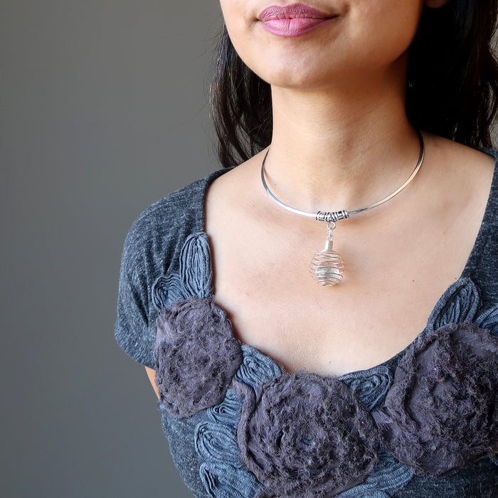 female wearing quartz cage necklace