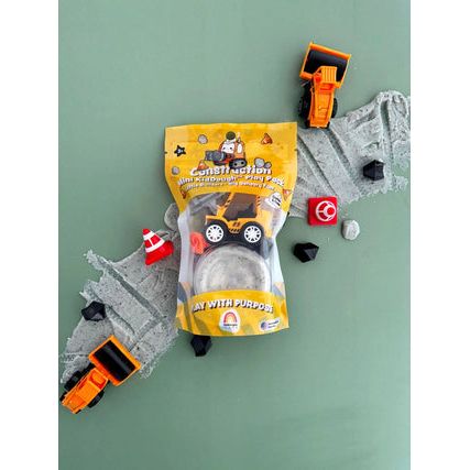Toy construction vehicles and a package on a green background