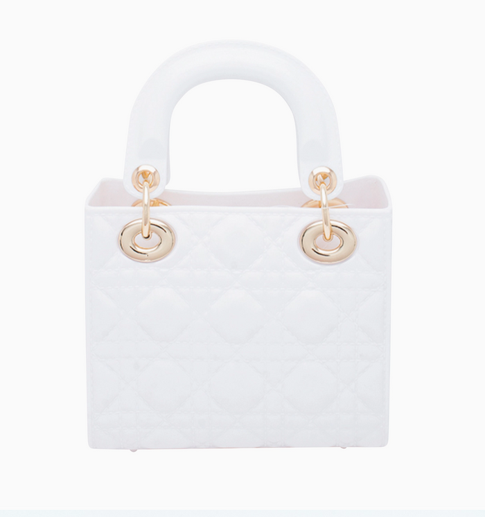 White handbag with gold handles on a white background