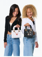 Two women holding small handbags with decorative elements on a white background