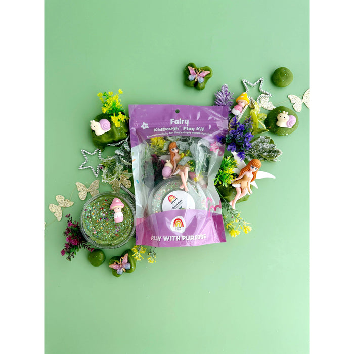 Fairy play kit with figurines and accessories on a green background