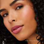 Close-up of a woman with glowing skin and natural makeup highlighting her cheekbones, showcasing the Glow Time Highlighter Stick | Jane Iredale for radiant skincare.