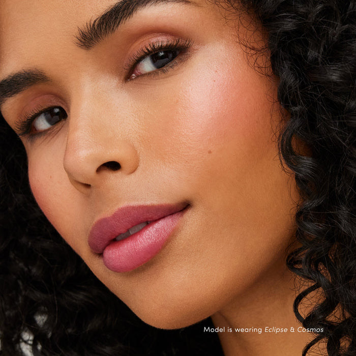 Close-up of a woman with glowing skin and natural makeup highlighting her cheekbones, showcasing the Glow Time Highlighter Stick | Jane Iredale for radiant skincare.