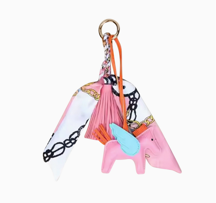 Colorful keychain with a pink horse design on a white background