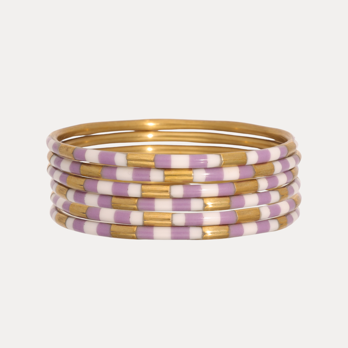 a stack of purple and gold bracelets