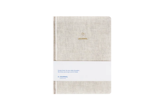 Beige linen hard cover journal on a white background