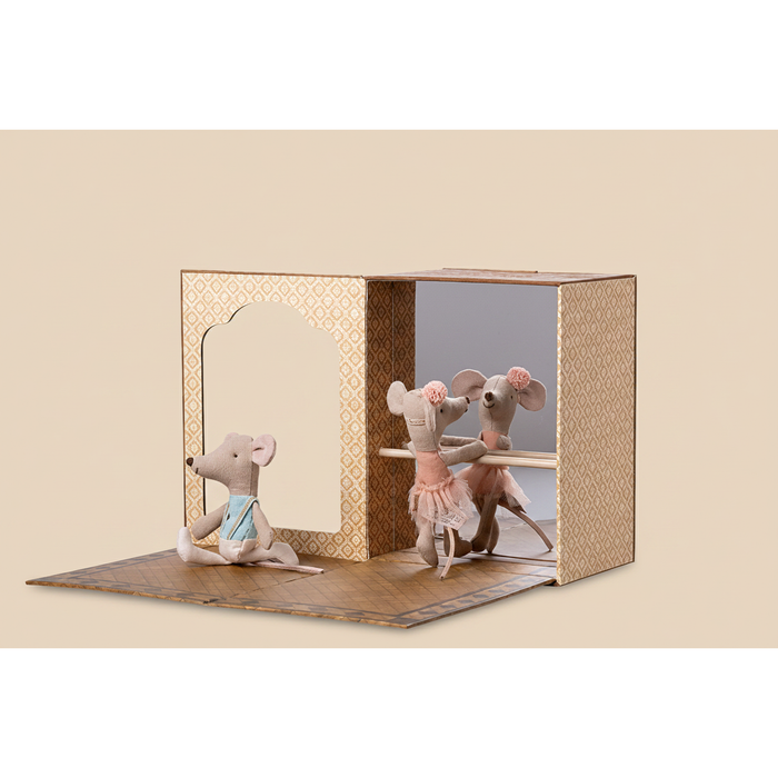 Toy mouse figures in a display case with a white background