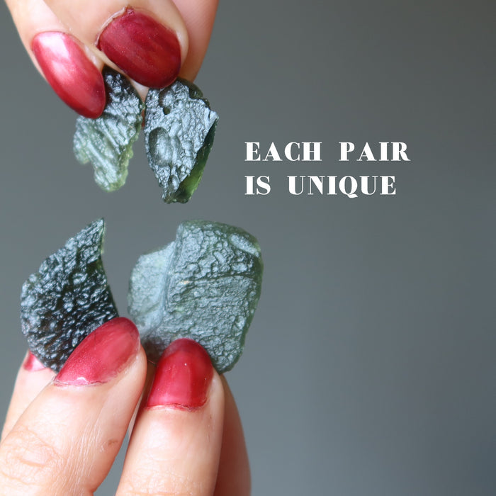 hands holding two pairs of moldavite tektites showing each pair is unique