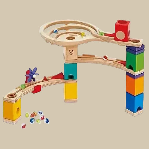 A colorful wooden marble run construction set with various colorful blocks and marbles set up mid-run.