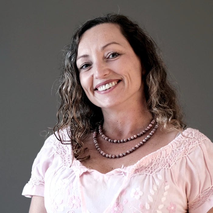 female modeling rhodochrosite necklaces