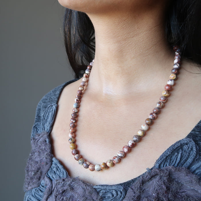 female wearing birds eye rhyolite necklace