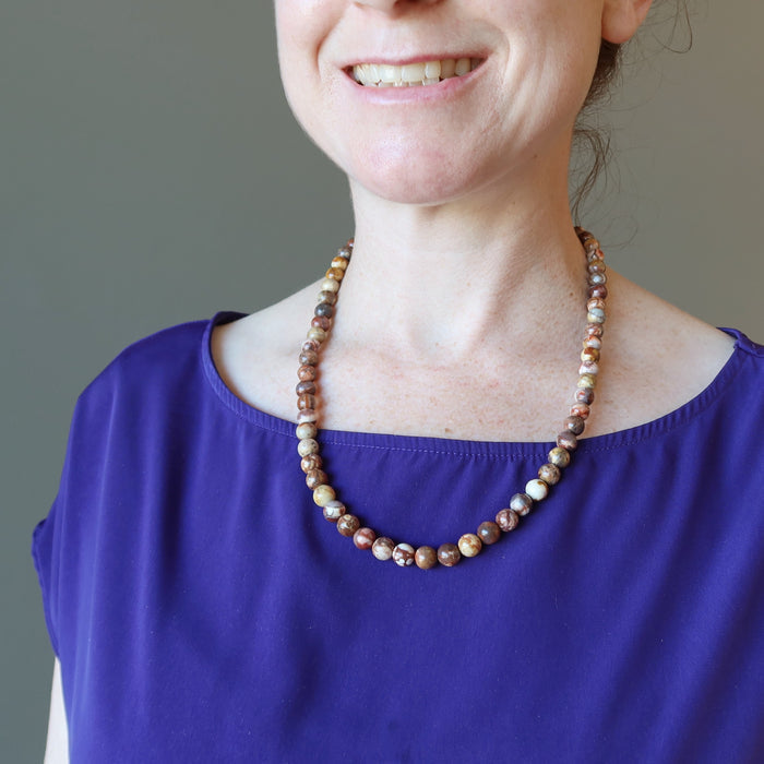 female wearing birds eye rhyolite necklace