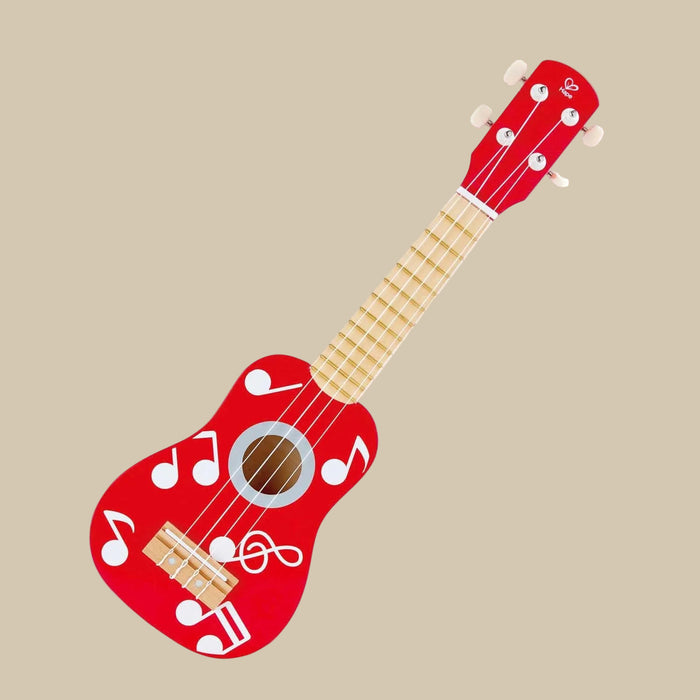 A red wooden ukulele with white musical notes and symbols, including a tuning key.