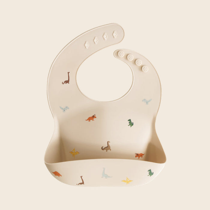 Beige baby silicone bib with dinosaur prints