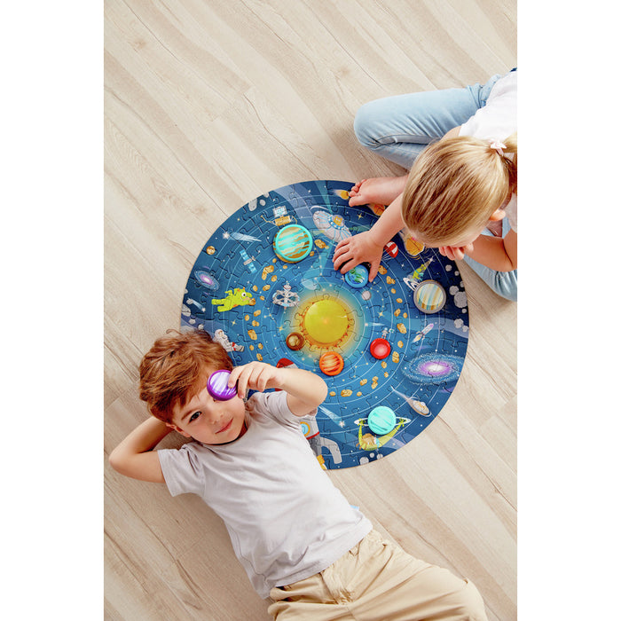 Children playing on a colorful solar system rug on a wooden floor.