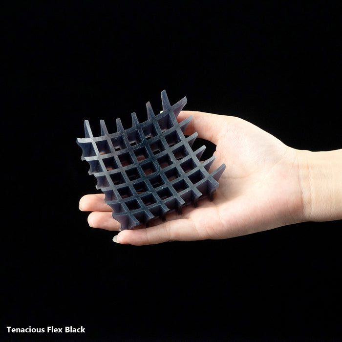 flexible 3D printing resin black open lattice grid cube held in palm showing flex