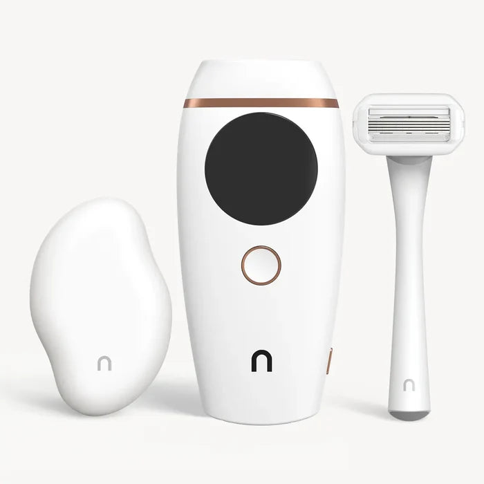 Nood Tool Kit in white including white Eraser exfoliating tool, Flasher 2.0 IPL device in white with rose gold accents, and white razor on light background