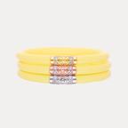 a yellow bracelet with gold and silver accents