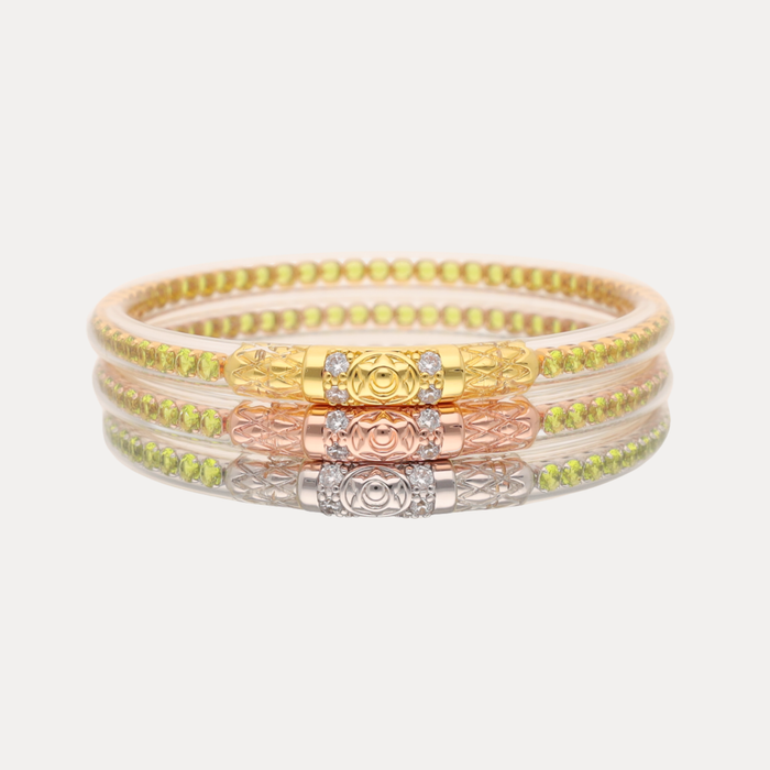 a stack of gold and silver bracelets