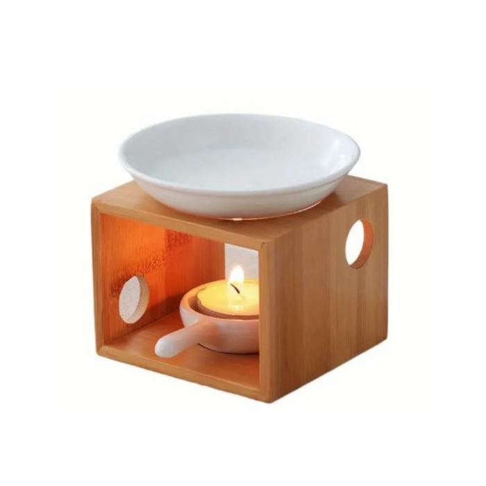Wooden warmer with a white bowl and a lit candle inside on a white background