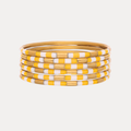 a stack of yellow and white bracelets